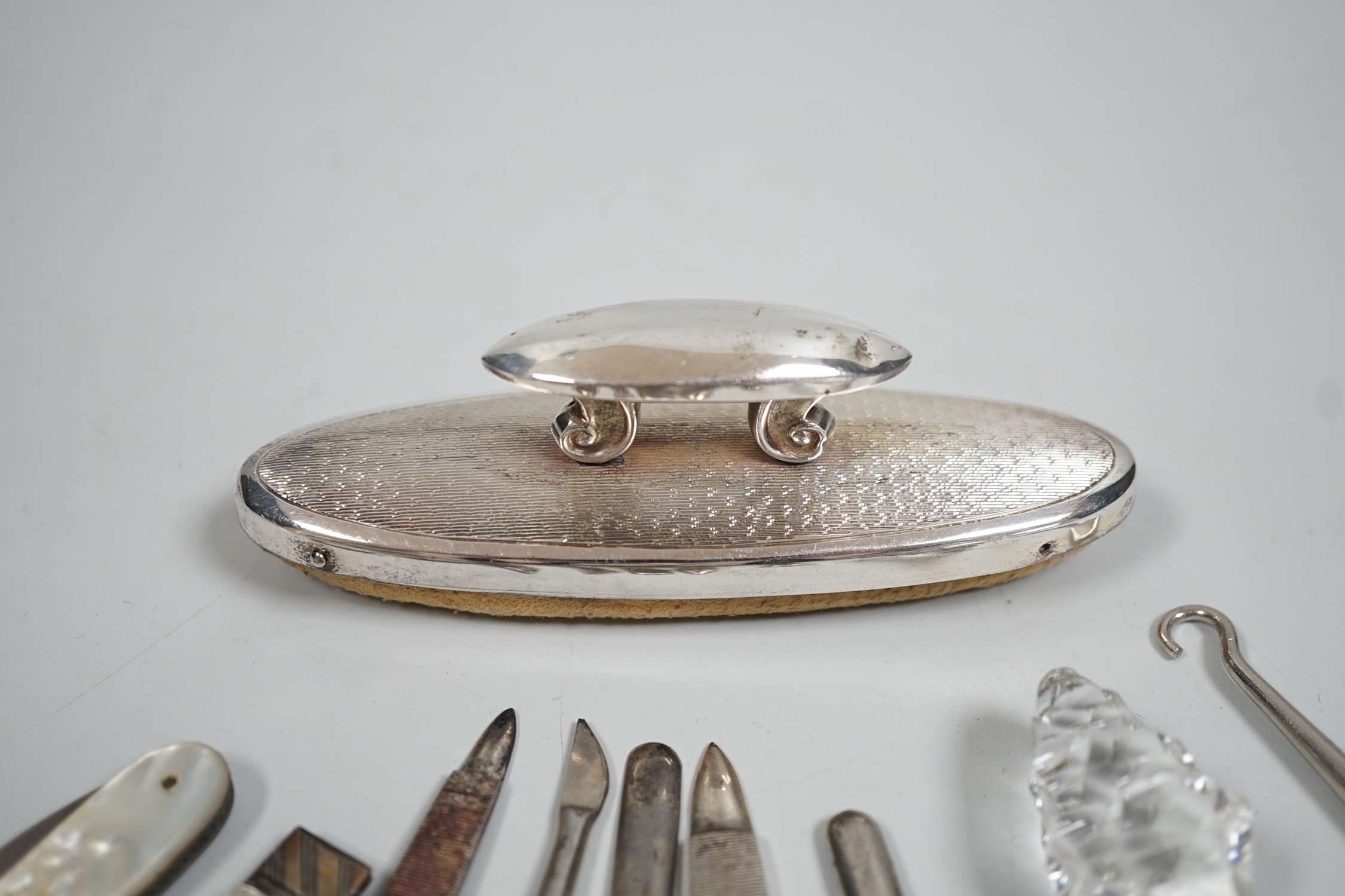 A small group of assorted manicure items and a leather travelling case containing a matched silver and mother of pearl travelling knife and fork.